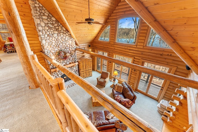 living room featuring wood ceiling, carpet floors, high vaulted ceiling, and ceiling fan