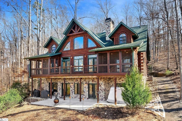 back of property featuring a patio area and a sunroom