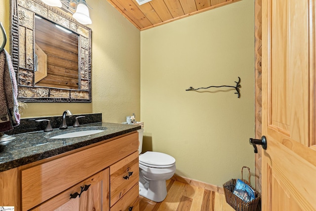 bathroom featuring hardwood / wood-style flooring, vanity, wooden ceiling, and toilet