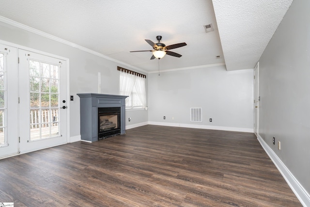 unfurnished living room with ornamental molding, ceiling fan, a textured ceiling, and dark hardwood / wood-style flooring