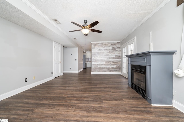 unfurnished living room featuring ceiling fan, crown molding, dark wood-type flooring, and a textured ceiling