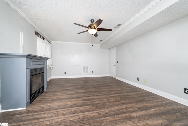 unfurnished living room with dark hardwood / wood-style flooring, ceiling fan, ornamental molding, and a textured ceiling