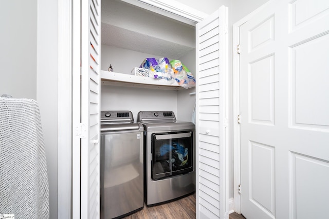 laundry area featuring washing machine and dryer and dark wood-type flooring