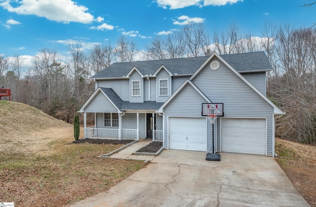 view of front of home with a garage, a front yard, and a porch