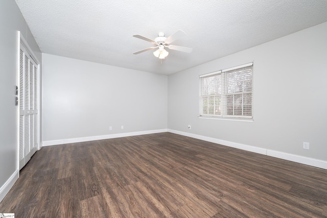 unfurnished room with ceiling fan, dark hardwood / wood-style floors, and a textured ceiling