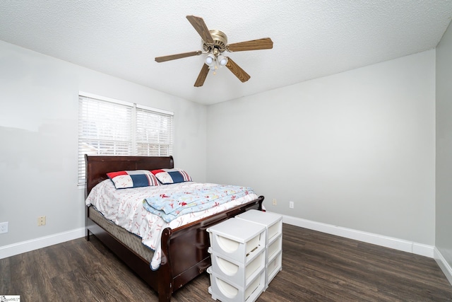 bedroom with ceiling fan, dark hardwood / wood-style flooring, and a textured ceiling