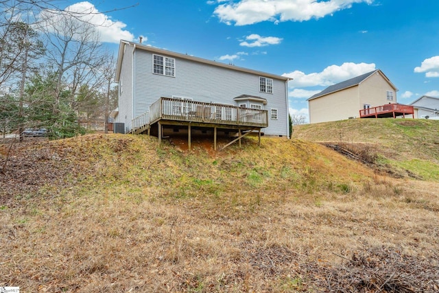 back of property with central AC and a deck