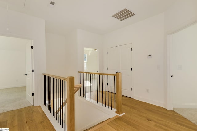 corridor with hardwood / wood-style flooring