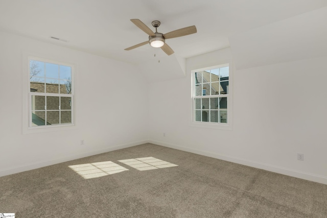 carpeted spare room with plenty of natural light and ceiling fan