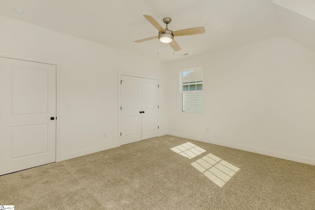 unfurnished bedroom featuring a closet, ceiling fan, and carpet flooring