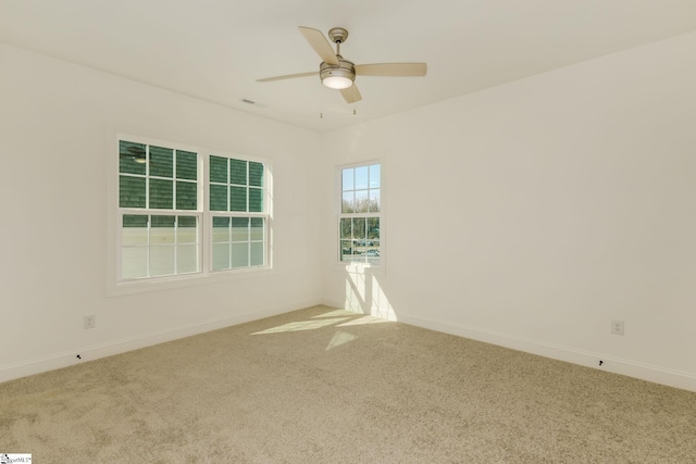 carpeted empty room featuring ceiling fan