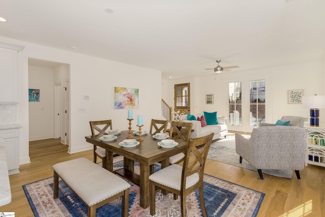 dining room featuring ceiling fan and light hardwood / wood-style flooring