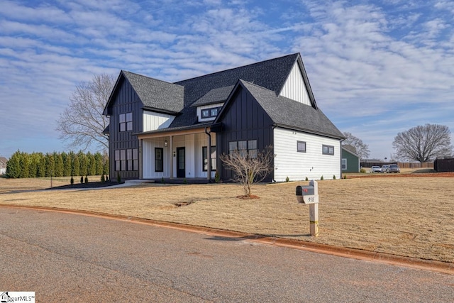 modern farmhouse style home with a front lawn