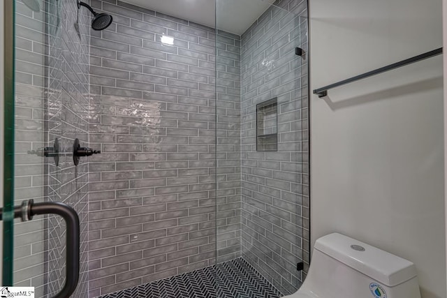 bathroom featuring walk in shower and toilet