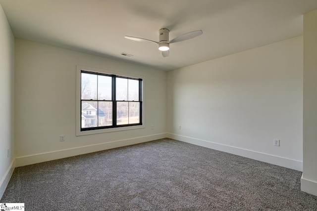 spare room featuring ceiling fan and carpet floors