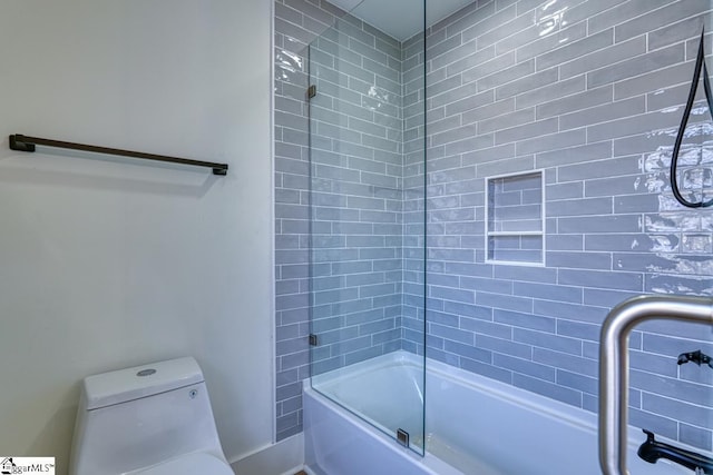 bathroom with enclosed tub / shower combo and toilet