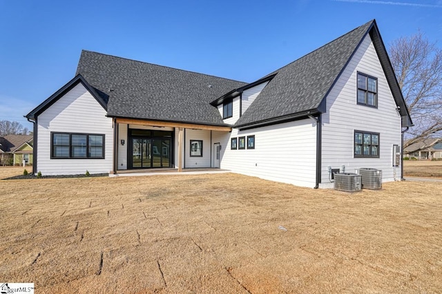 back of house featuring a yard, a patio area, and central AC