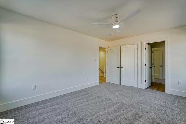 unfurnished bedroom with ceiling fan, ensuite bathroom, and carpet