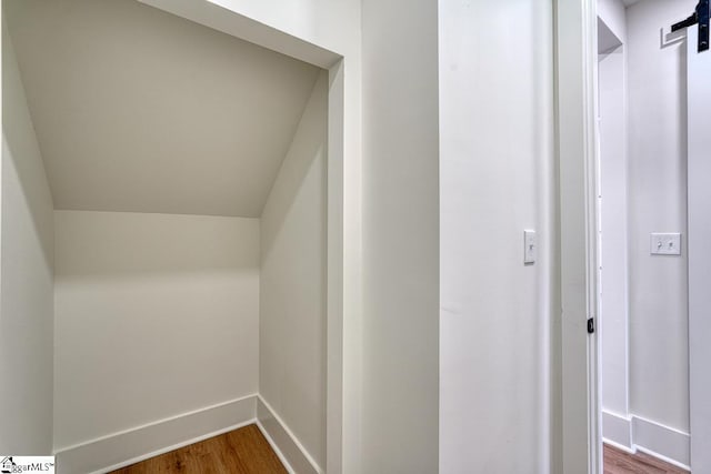 interior space with hardwood / wood-style flooring and a barn door