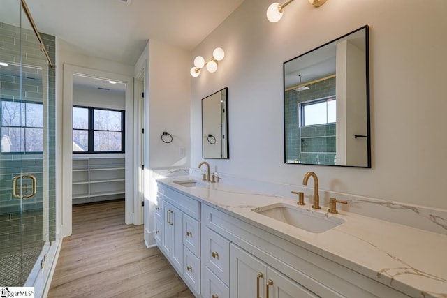 bathroom with vanity, an enclosed shower, and hardwood / wood-style floors