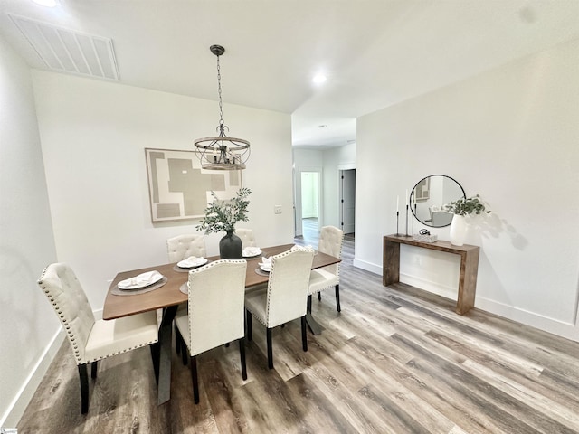 706 Cheyanne Ct, Greer, SC 29651 - dining space featuring a chandelier, wood finished floors, and baseboards