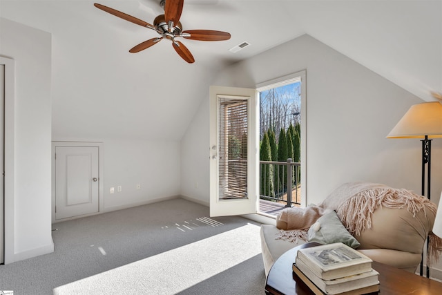 sitting room with ceiling fan, lofted ceiling, and light carpet