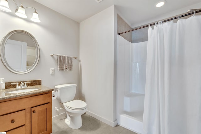 bathroom with vanity, toilet, curtained shower, and tile patterned flooring