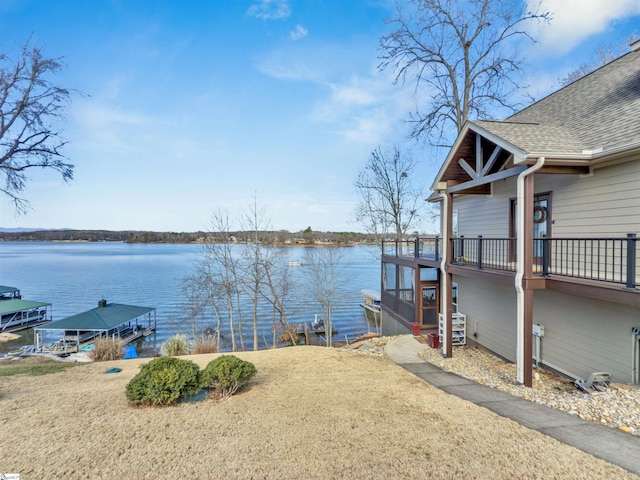 dock area featuring a water view and a yard