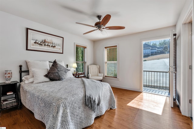 bedroom with ceiling fan, access to exterior, and hardwood / wood-style floors