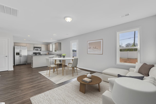 living room with dark hardwood / wood-style flooring