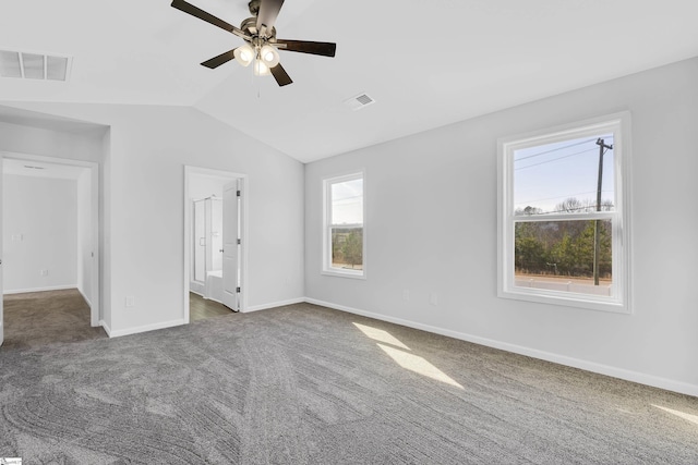 unfurnished bedroom featuring dark colored carpet, lofted ceiling, and ceiling fan