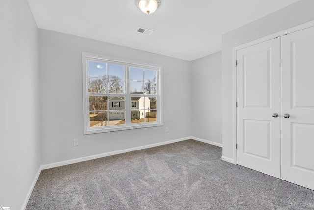 unfurnished bedroom with carpet and a closet