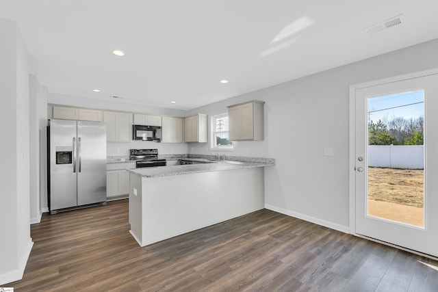 kitchen featuring dark hardwood / wood-style floors, kitchen peninsula, sink, and black appliances