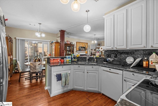 kitchen with white cabinetry, white dishwasher, kitchen peninsula, and pendant lighting