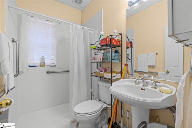 bathroom with a shower with curtain and toilet