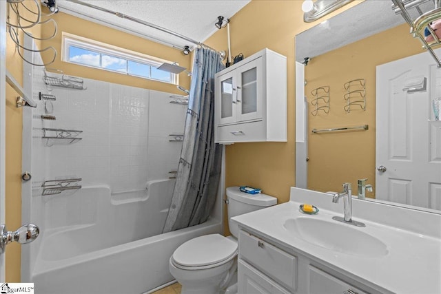 full bathroom featuring vanity, a textured ceiling, shower / bath combo, and toilet