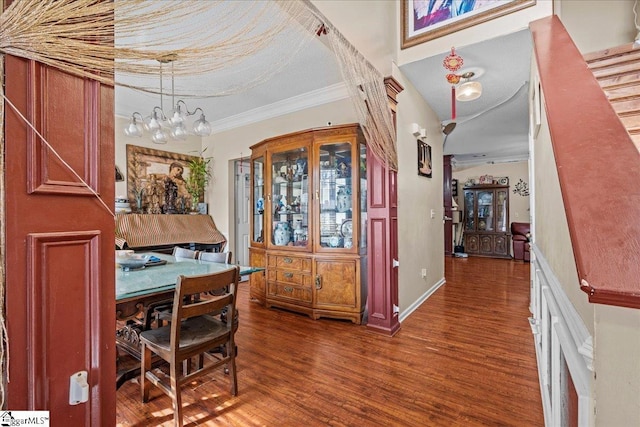 dining space with ornamental molding and dark hardwood / wood-style floors