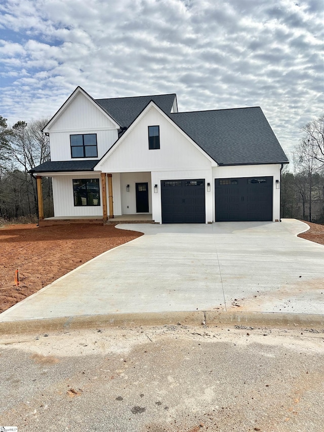 modern inspired farmhouse featuring a garage