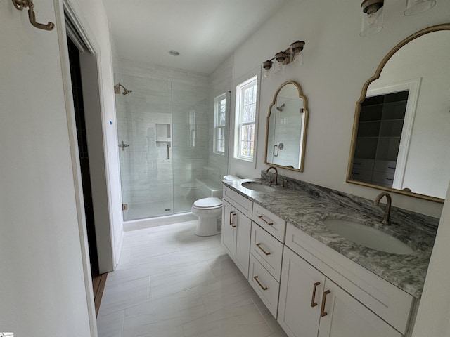 bathroom with toilet, vanity, and walk in shower