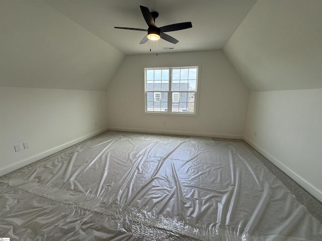 additional living space featuring lofted ceiling, light carpet, and ceiling fan