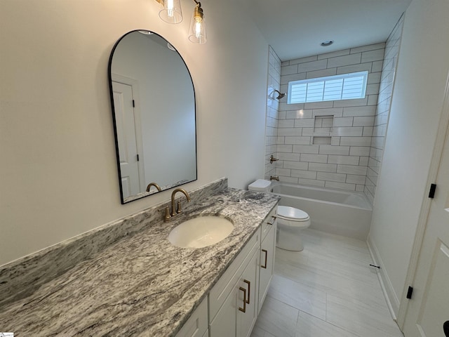 full bathroom with vanity, tiled shower / bath combo, and toilet