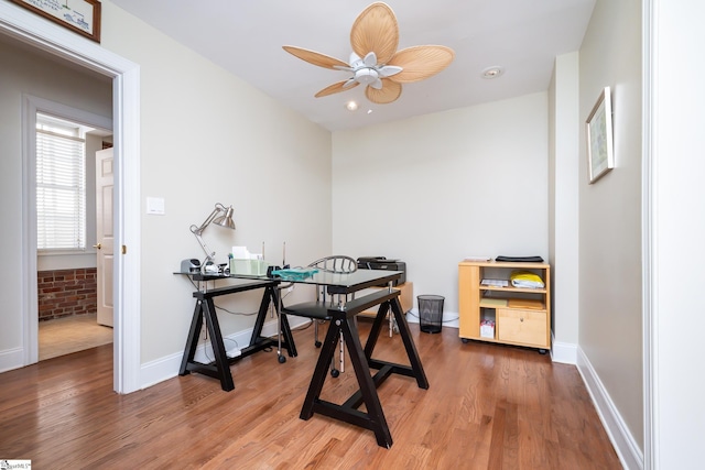 office area featuring wood-type flooring and ceiling fan