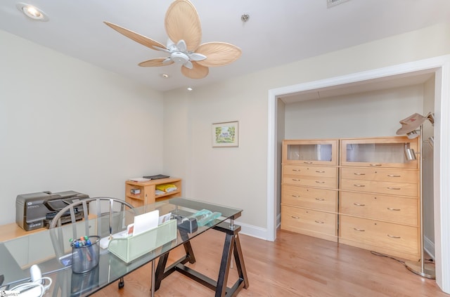 office space with light hardwood / wood-style floors and ceiling fan