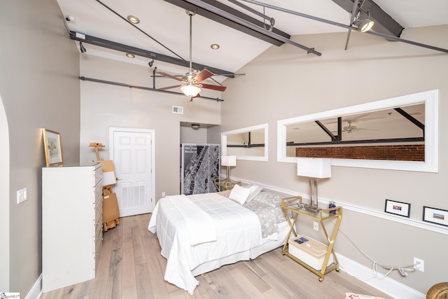 bedroom with beam ceiling, high vaulted ceiling, and light wood-type flooring