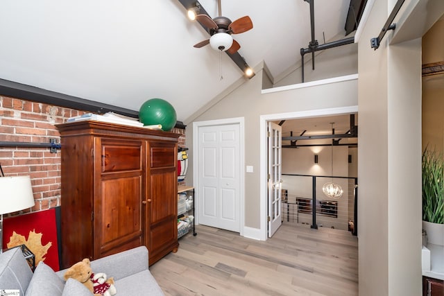 interior space featuring light hardwood / wood-style flooring, vaulted ceiling, and ceiling fan