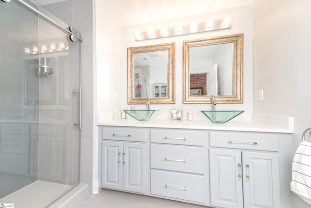 bathroom featuring a shower with door and vanity