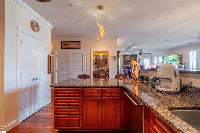 kitchen with stone countertops, decorative light fixtures, dark hardwood / wood-style flooring, stainless steel dishwasher, and crown molding