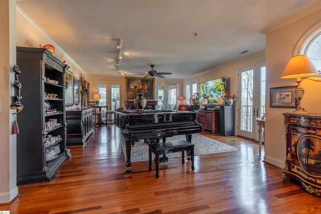 misc room featuring hardwood / wood-style floors, track lighting, ornamental molding, and french doors