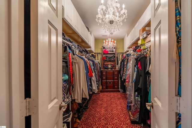 walk in closet featuring a notable chandelier