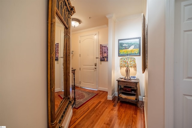 corridor with hardwood / wood-style flooring and ornamental molding